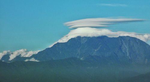 Scenic view of mountains against blue sky