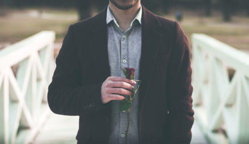 Close-up of a man holding rose