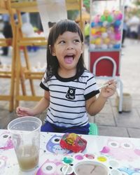 Cute smiling girl having food at restaurant