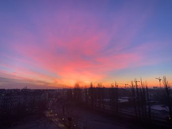 Silhouette city against sky during sunset