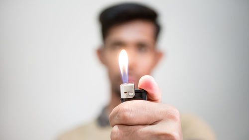 Close-up portrait of man holding candles