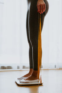 Low section of woman standing on floor