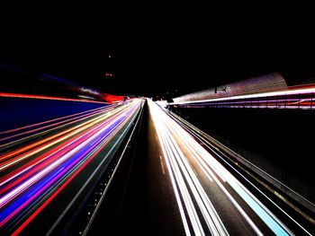 Light trails on road in city at night