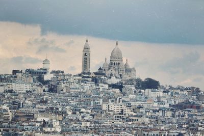 High angle view of city against cloudy sky