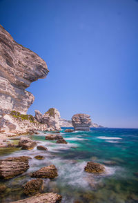 Scenic view of sea against clear blue sky