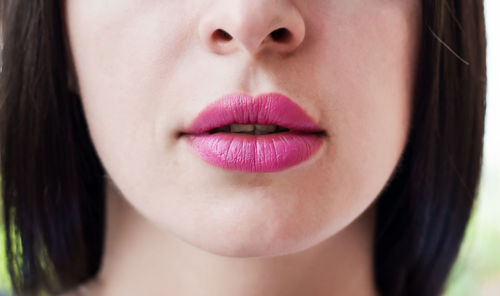 Close-up of woman wearing pink lipstick