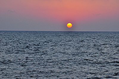 Scenic view of sea against clear sky during sunset