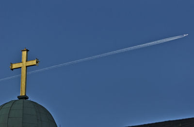 High section of cross against clear blue sky