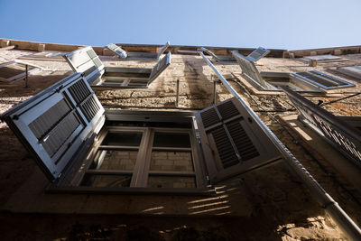 Directly below shot of old building against clear sky