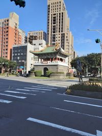 City street and buildings against sky