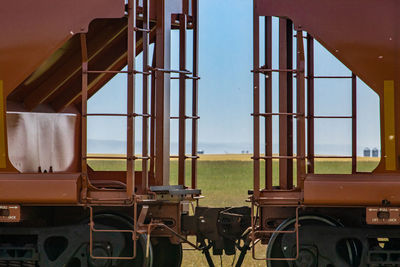 Close-up of train on field against sky