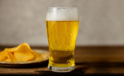 Close-up of beer glass on table