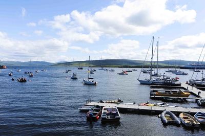 Boats sailing in sea against sky
