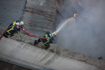 Firemen extinguishing fire