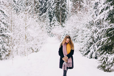 Full length of woman standing on snow covered land