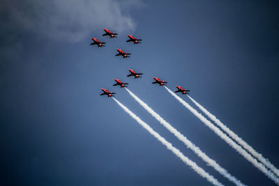 Low angle view of airshow against sky