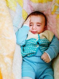 High angle view of cute toddler resting in hammock