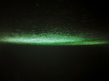 Defocused image of illuminated lights on field at night
