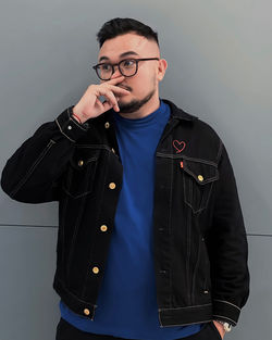 Young man standing against white background