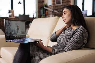 Young woman using laptop at home