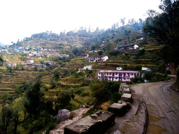 High angle view of houses in town against clear sky