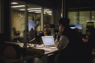 Businesswoman with dedication working on laptop at work place