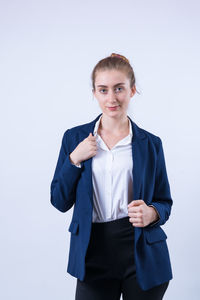 Portrait of a smiling young woman against white background