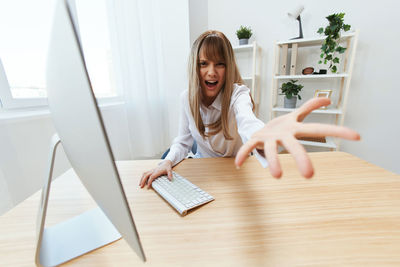 Portrait of young woman working at office