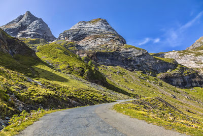 Road amidst mountains against sky