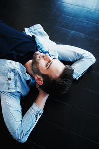 Low section of man sitting on bed