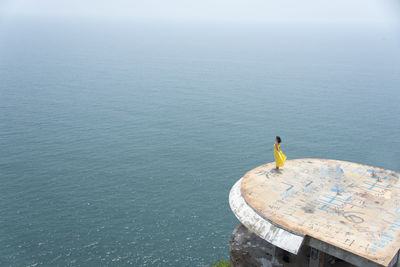 High angle view of man looking at sea