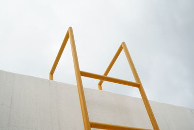 Low angle view of ladder against sky