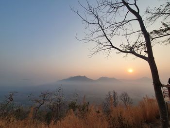 Scenic view of silhouette mountain against sky at sunset