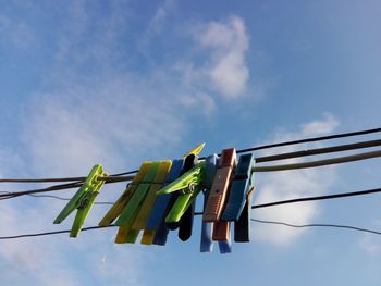 Low angle view of clothes drying on clothesline against sky