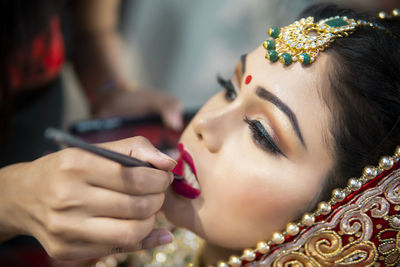 Close-up of woman applying make-up