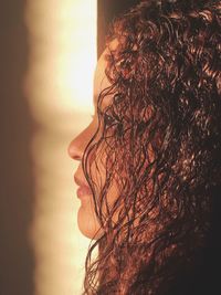 Side view of woman with curly hair looking away