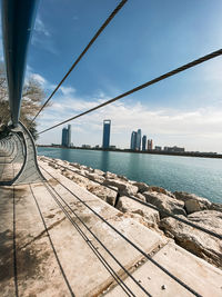 Bridge over sea against sky in city