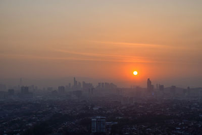 High angle view of buildings against sky during sunset