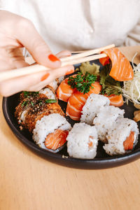 Cropped hand holding food in plate