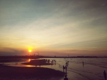 Scenic view of beach against sky during sunset