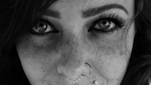 Close-up portrait of woman wearing nose rings