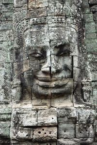 View of old statue against temple