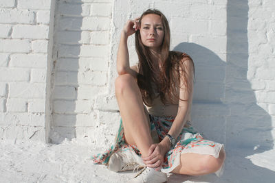 Portrait of young woman sitting outdoors