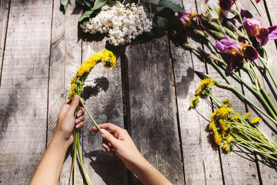 Close-up of woman hand holding flowering plant