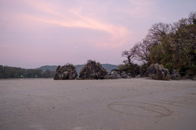 Scenic view of beach against sky during sunset