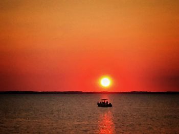Scenic view of sea against orange sky
