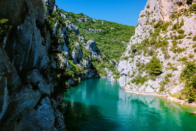 Scenic view of rocks and trees against sky