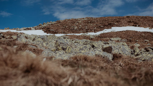 Low angle view of rocks on land against sky