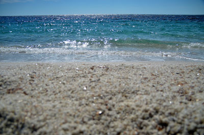 Scenic view of beach against clear blue sky