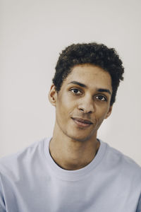 Smiling young man against white background